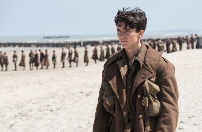 Tommy (Fionn Whitehead) contemplates his rescue options in Dunkirk. Image via .thepicreview.com | Dunkirk movie review | onetakekate.com