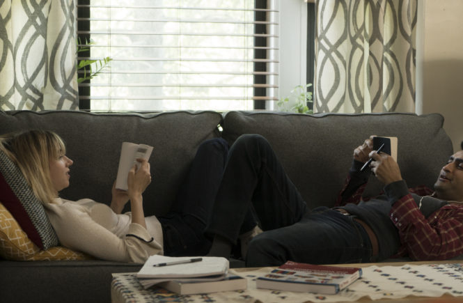 Emily (Zoe Kazan) and Kumail (Kumail Nanjiani) get comfy in The Big Sick. Image via Studio Canal UK | The Big Sick movie review | onetakekate.com